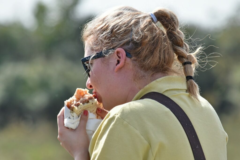 Woman eating a burrito.