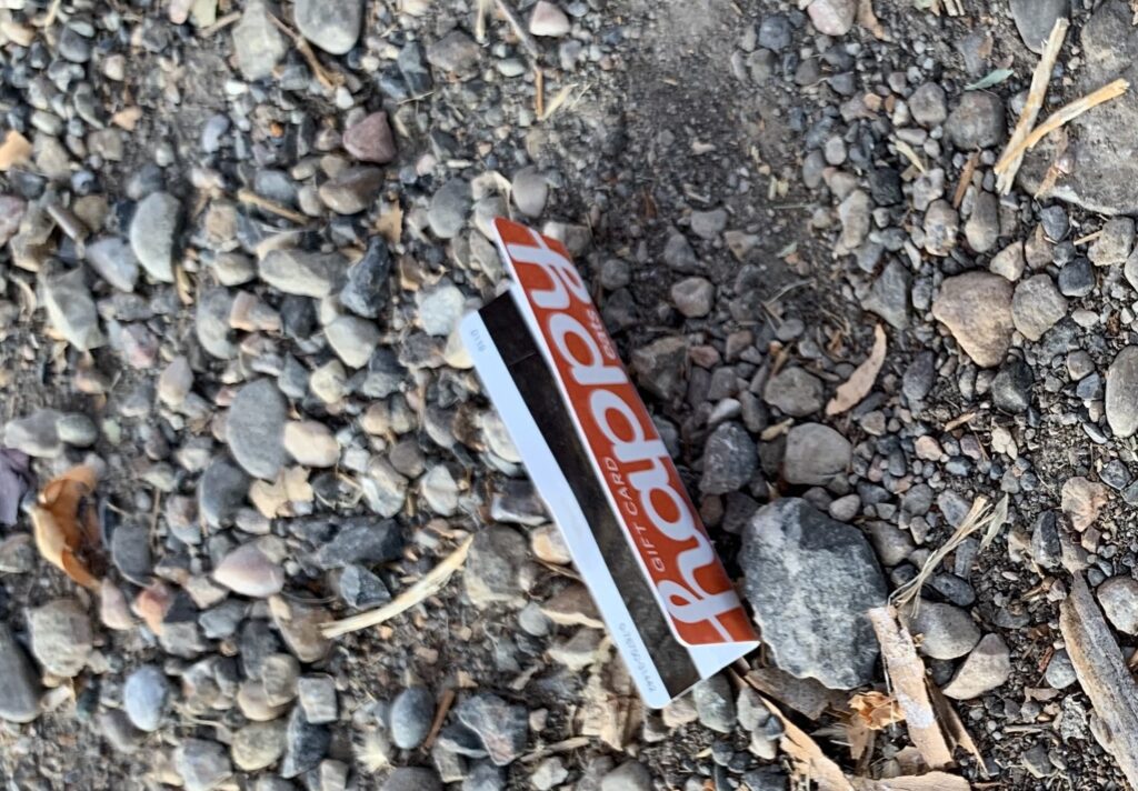Bent, discarded happy gift card.
