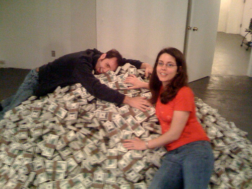 blurry picture of an everyday young couple on a pile of money.