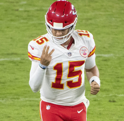 A football player in a red uniform counting to 3.