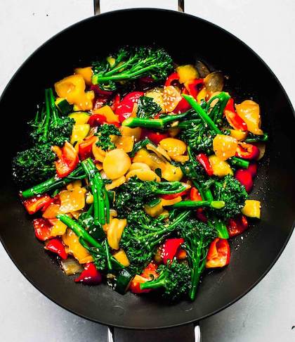 A prepared stir-fry of vegetables in a wok.