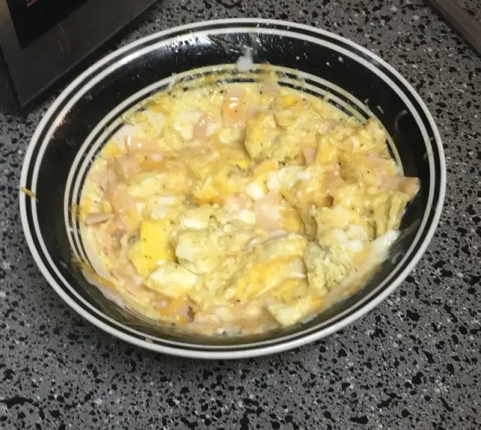 A picture of a weird scrambled eggs concoction that looks very unappetizing.