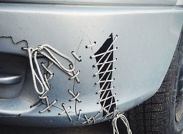 A car bumper that's broken but held together with shoelace stile stitching.
